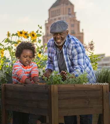 Actor portrayal of a grandfather gardening with his grandchild