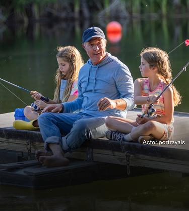Actor portrayal of a grandfather fishing with his granddaughters