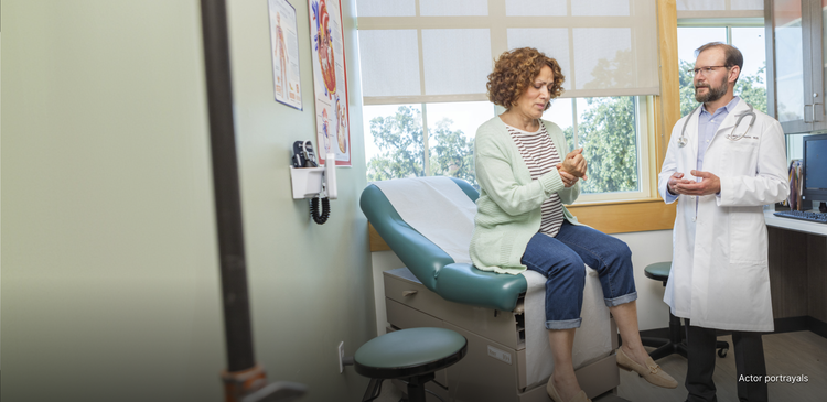 Actor portrayal of a woman in exam room speaking to her doctor