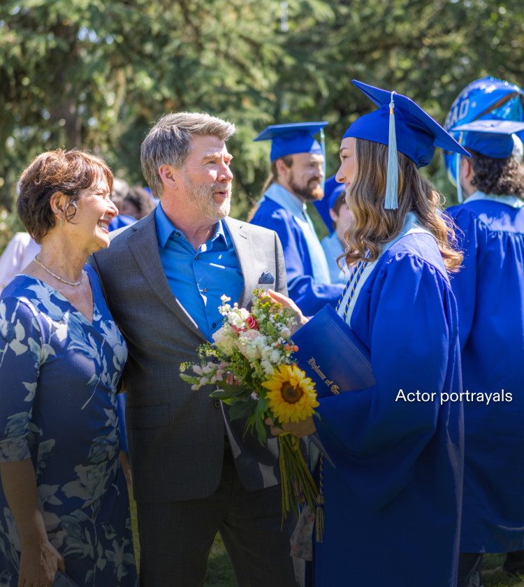 Actor portrayal of a family engaging in conversation at their daughter's graduation