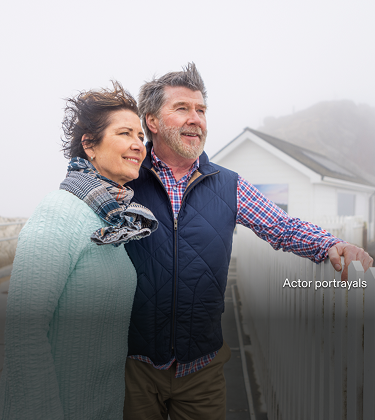 Actor portrayal of an older couple outdoors with wind in their hair