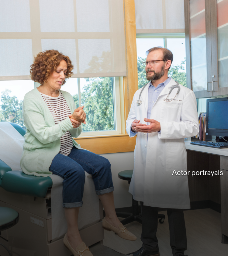 Actor portrayal of a woman in exam room speaking to her doctor