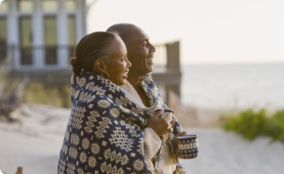 Patient and caregiver enjoying seaside sunset