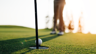 Patient golfing at sunset