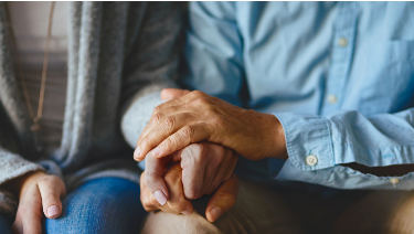 Patient holding hands with loved one