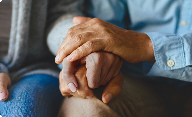 Patient holding hands with loved one