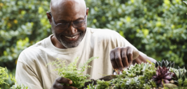 Patient smiling while gardening