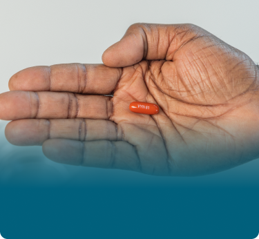 A hand with palm facing up holding a VYNDAMAX (tafamidis) pill