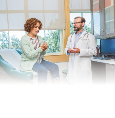 Actor portrayal of a woman in exam room speaking to her doctor